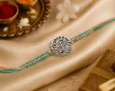 Silver Finish Teal & Peach Braided Rakhi with Floral Swastika Centerpiece